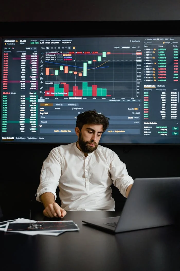 Home Focused man working on cryptocurrency trading with charts displayed in office.